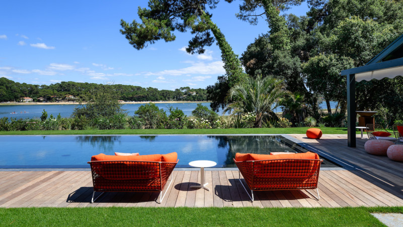Au bord de l’eau piscine miroir terrasse bois jardin fauteuil reflets ocean orange esprit piscine 2022 Piscine miroir minéral 3D Gris ardoise 
