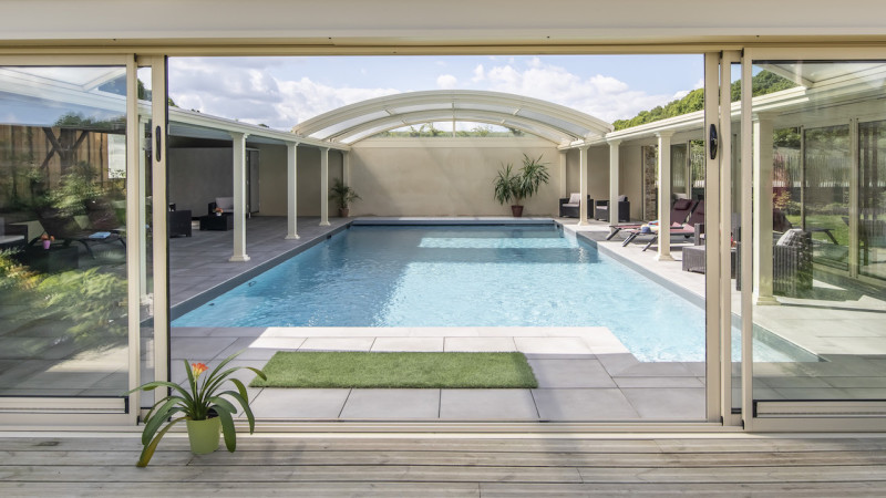 Abri de piscine Véranda Gris anthracite / Piscine à ciel ouvert : piscine collective abri ouverture ciel bleu margelles ceramique fenetres esprit piscine 2022